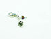 flower charm with red birthstone